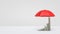 3d rendering of an open red umbrella on white background covering several stacks of money placed as a growing graph.