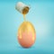 3d rendering of a overturned metal bucket leaks golden paint all over a giant chicken egg on a blue background.