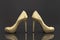 3D rendering of a pair of golden high heels