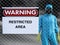 3D rendering of person in hazmat suit in restricted area