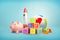 3d rendering of piggy bank, several alphabet cubes, toy blocks, a rocket and a large inflated colorful rubber ball