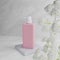3D rendering pink lotion headpump bottle on white marble background with white flower