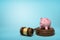 3d rendering of pink piggy bank standing on sounding block with gavel lying beside on light-blue background with copy