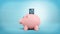 3d rendering of a pink piggy bank stands in a side view on a blue background with a credit card stuck into its coin slot