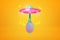 3d rendering of pink UFO flying against amber background and carrying blue egg with pink spots.