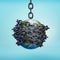 3d rendering of planet Earth hung on a chain and bound with chains all over.