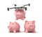 3d rendering of quadcopter carrying pink piggy bank and putting it down to two identic piggy banks isolated on white