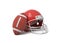 3d rendering of a red American football helmet lying near a red oval ball on a white background.