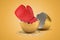 3d rendering of red boxing glove that just hatched out from golden egg on light ocher background.
