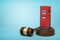 3d rendering of red filling station on round wooden block and brown wooden gavel on blue background