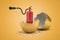 3d rendering of red foam fire extinguisher hatching out of golden egg on yellow background