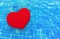 3d rendering. A red heart floating on waving swimming pool surface background.