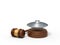 3d rendering of silver metal UFO on round wooden block and brown wooden gavel