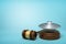 3d rendering of silver metal UFO on round wooden block and brown wooden gavel on blue background