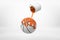 3d rendering of small silver paint bucket turned upside down with orange paint pouring on white basketball ball isolated