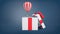 3d rendering of a small striped hot air balloon flying out of a large white gift box with a red ribbon bow.