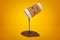 3d rendering of thick broun liquid spilling out of paper coffee cup on yellow background