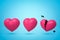 3d rendering of three pink hearts in row, left heart broken in two, on light blue background.