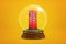 3d rendering of tiny red fuel dispenser inside glass ball globe on amber background.
