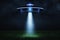 3d rendering of a UFO at night with a beam of light coming out of the hatch and lighting a landing point in the green