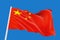 3d rendering. Windy waving China national flag with clipping path isolated on blue sky background.