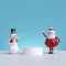 3d Santa Claus and snowman, standing near blank podium, isolated on blue background. Cheerful Christmas characters, funny toys