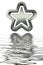 3d silver star with reflection in water