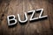 3d white letters - BUZZ - on textured rustic wood