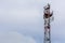 3G, 4G, 5G, wireless and cell phone telecommunication tower close-up on cloudy daylight sky background with copy space