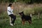 4.09.21 Russia Krasnodar dog show of the German Shepherd breed. Woman is sitting in clearing holding orange ball in her hands and