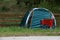 4/12/2020: Monterey, CA.  A blue tent and bright red grocery cart being used by a homeless person by the bike trail.