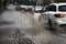 4 x 4 Car driving through Flooded road splashing sidewalk / pavements