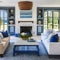 4 A beachy, coastal-inspired living room with a mix of blue and white upholstery, a large fireplace mantle with coastal decor, a