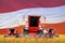 4 bright red combine harvesters on wheat field with flag background, Austria agriculture concept - industrial 3D illustration