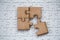 4 Four brown pieces of puzzle on a white jigsaw background, last piece of jigsaw puzzle to complete the mission, Business