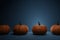 4 Halloween realistic pumpkins on blue dark background 3d illustration