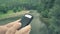 4 k beautifull girl standing near the mountain river watching her smartphone, typing message, taking her time among of