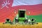 4 light green combine harvesters on rural field with flag background, Oman agriculture concept - industrial 3D illustration