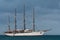 4 mast tall ship anchored with a tender boat in the port of Cozumel, Mexico