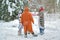 4 people, 2 girls and 2 mens in kigurumi in snow winter forest. Pajama costume pig cow kangaroo and cat. Fun with friends, walking