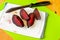 4 pieces of red beetroot, knife, board
