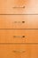 4 wooden closed drawers vertical front view