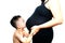 4 year old boy kissing pregnant belly of his mom