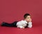 4-year-old boy portrayed with gestures in studio with color background.