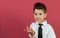 4-year-old boy portrayed with gestures in studio with color background.