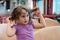 The 4 year old girl plays happily in the ferry boat that takes her to Greece