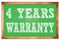 4 YEARS WARRANTY words on green wooden frame school blackboard