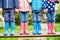 4 young children in coats, jeans and wellies