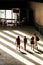 4 young people walk towards the exit of The Turbine Hall, Tate Modern, London