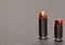 A 40 caliber hollow point bullet and a 44spl red tipped bullet together on a gray background